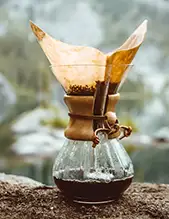 Filtering the coffee from the coffee grounds