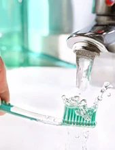 Toothbrush under faucet